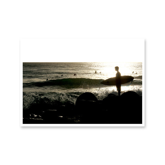 Solo Surfer on the Rocks